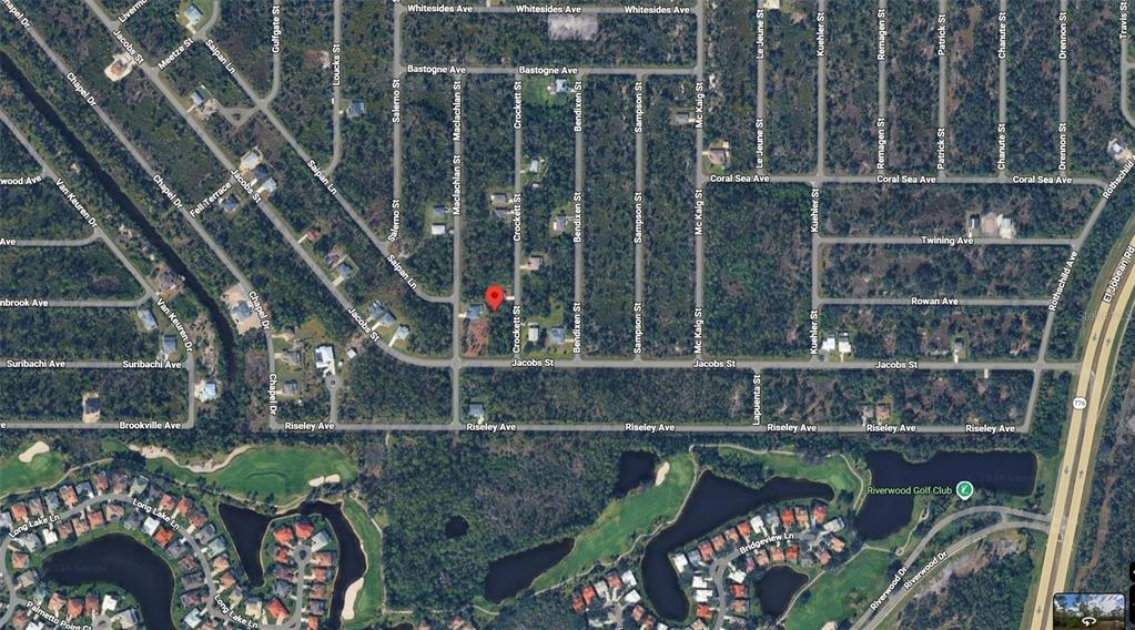 This is a satellite map view of a residential neighborhood with a red location marker — 2473 CROCKETT STREET, PORT CHARLOTTE, FL