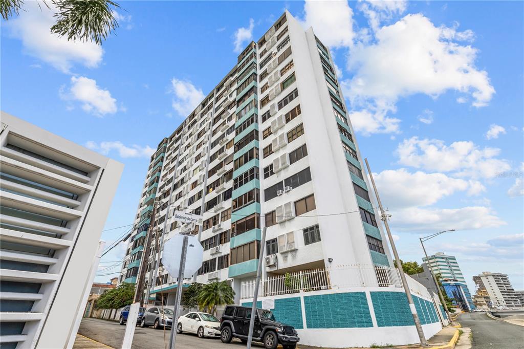 A low-angle exterior view of a tall white apartment building with teal accents — 212 DIEZ DE ANDINO UNIT 604, SAN JUAN, PR