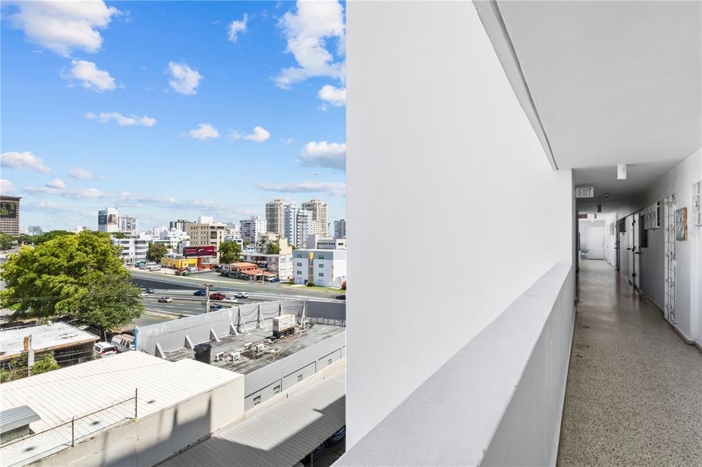 An outdoor apartment building walkway overlooks a city skyline and a nearby highway — 212 DIEZ DE ANDINO UNIT 604, SAN JUAN, PR