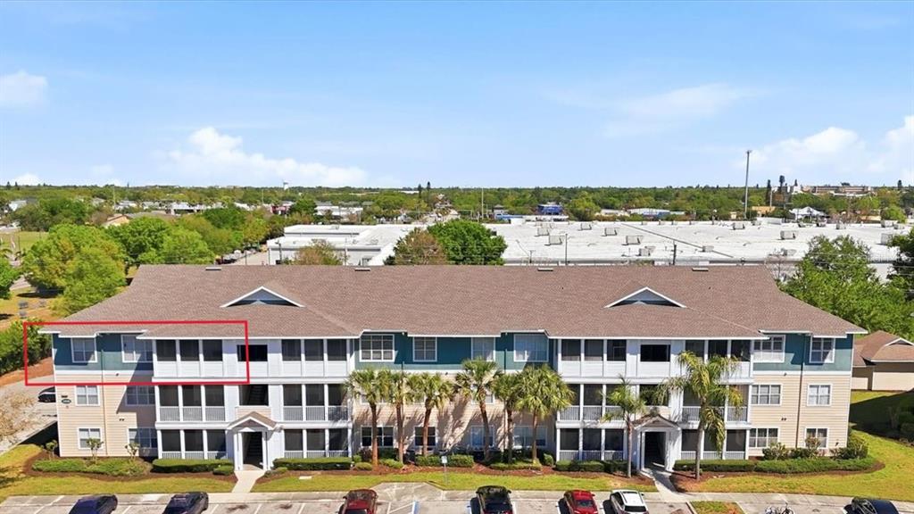 An exterior view of a multi-story apartment building with a red box highlighting a balcony — 4802 51ST STREET W UNIT 1417, BRADENTON, FL