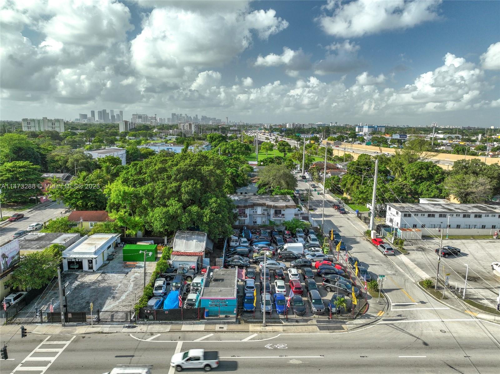 An aerial view shows a car dealership lot with many vehicles parked on a city street — 540 NW 79th St, Miami FL 33150, MIAMI, FL