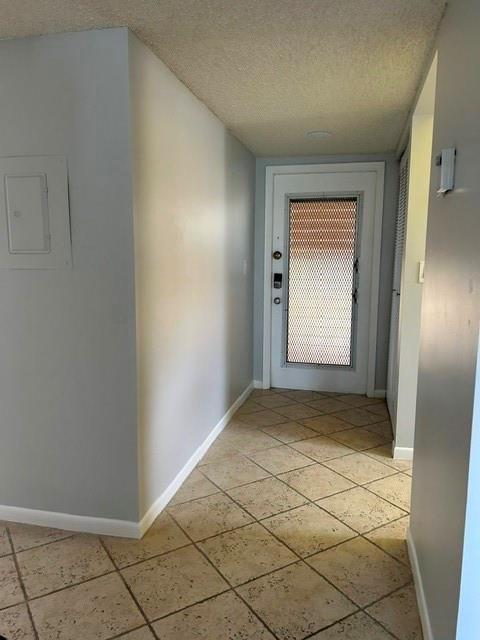 An entryway features light gray walls, a tiled floor, and a door with a security screen — 6770 Royal Palm Boulevard # 301, Margate FL 33063, MARGATE, FL