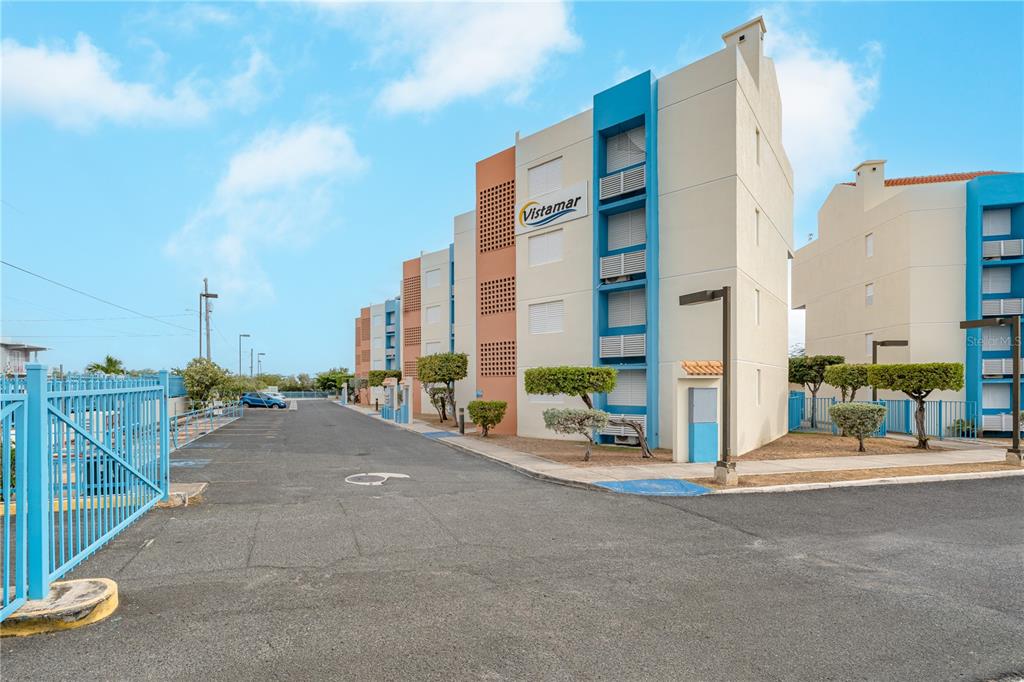 An exterior view of the Vistamar apartment complex featuring multi-story buildings and a parking lot — SR-3301 km 2.8 interior VISTAMAR EL COMBATE CONDOMINIUM BEACH UNIT 410 C, CABO ROJO, PR