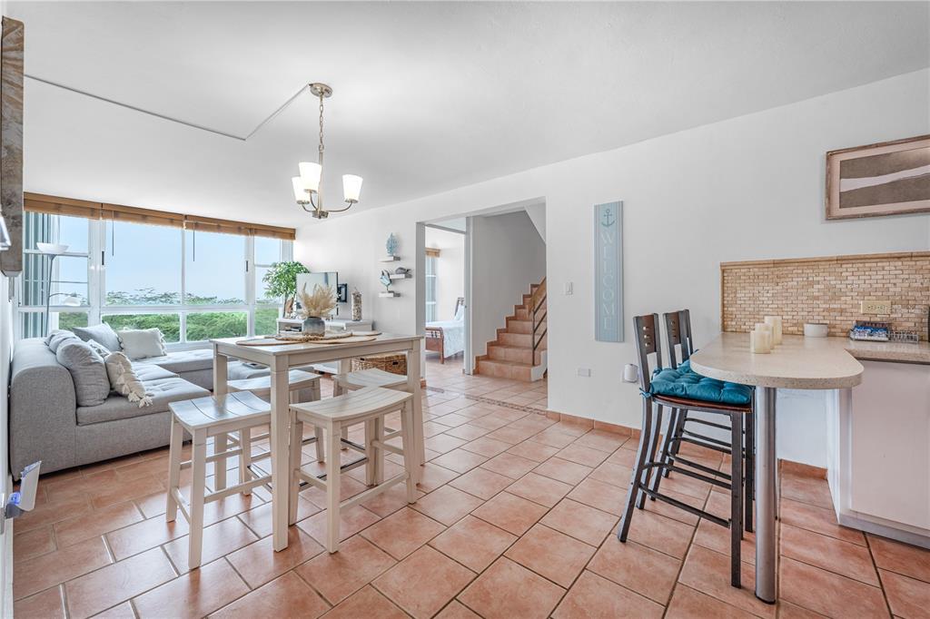 A living and dining area features tile floors, a breakfast bar, and large windows — SR-3301 km 2.8 interior VISTAMAR EL COMBATE CONDOMINIUM BEACH UNIT 410 C, CABO ROJO, PR