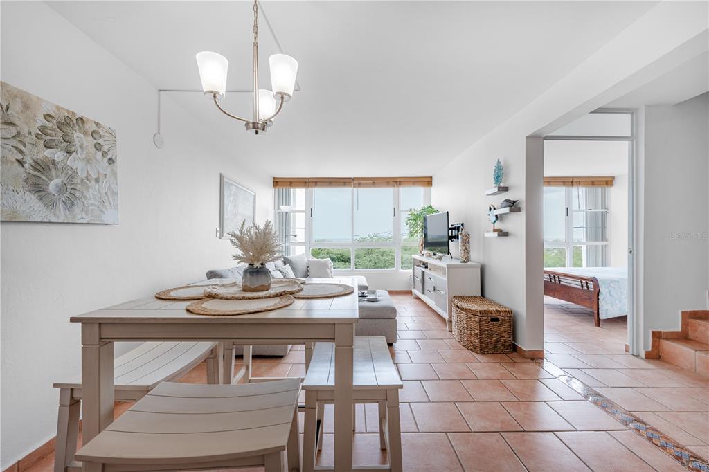 A dining area and living room with tile floors, a large window, and adjacent bedroom — SR-3301 km 2.8 interior VISTAMAR EL COMBATE CONDOMINIUM BEACH UNIT 410 C, CABO ROJO, PR