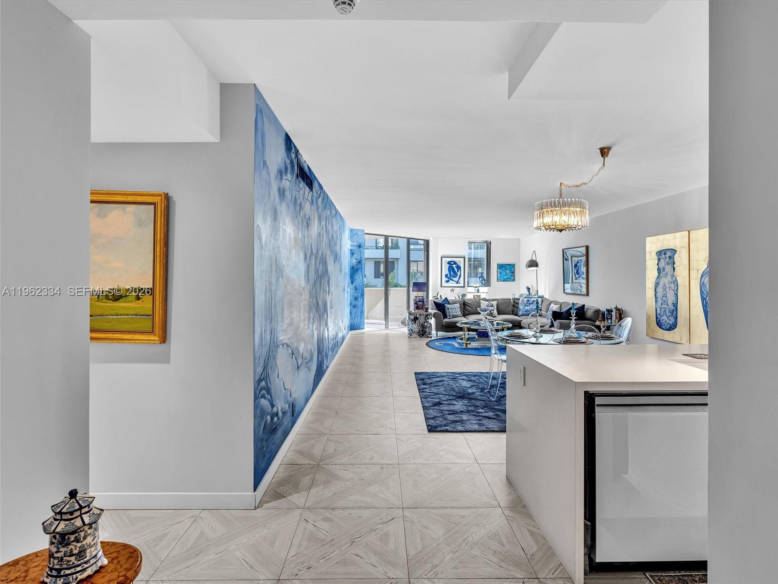 A living area features a large blue mural, tile flooring, and a glass dining table — 101 Crandon Blvd # 479, Key Biscayne FL 33149, KEY BISCAYNE, FL