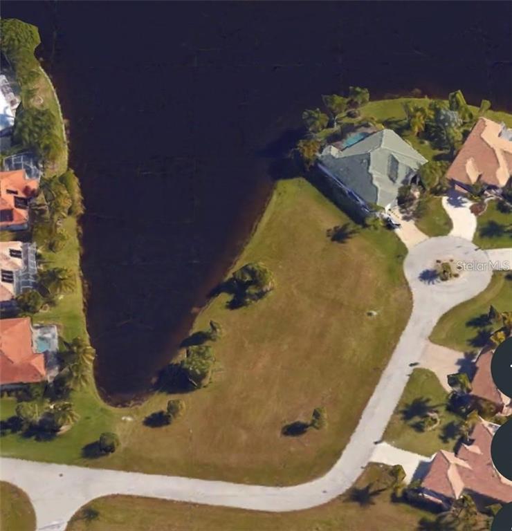 An aerial view shows a vacant waterfront lot situated at the end of a cul-de-sac — 17209 BARCREST LANE, PUNTA GORDA, FL