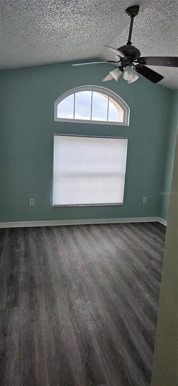 A bedroom with light blue walls, gray wood-look flooring, and a ceiling fan — 3186 BENTLEY DRIVE, PALM HARBOR, FL