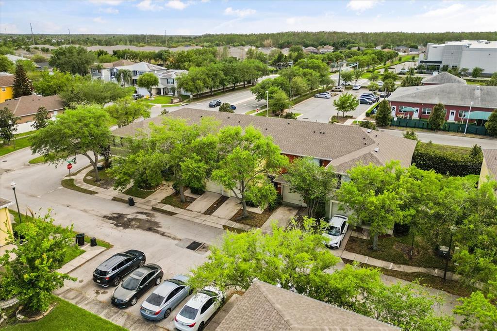 An aerial view shows a multi-unit residential building with a parking lot and surrounding trees — 13536 TEA ROSE WAY UNIT 119, ORLANDO, FL