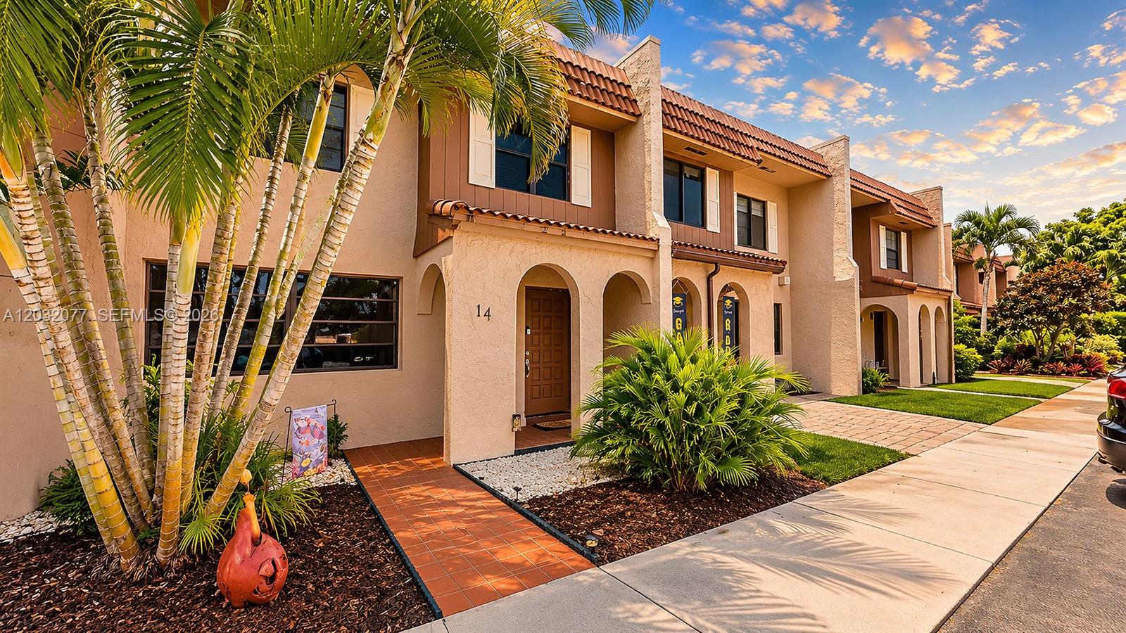 A two-story townhouse exterior features a tiled walkway, arched entryway, and palm trees — 14 Matador Ln # 27, Davie FL 33324, DAVIE, FL
