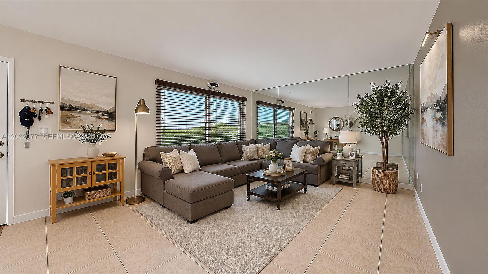 A living room features a large sectional sofa, a coffee table, and a mirrored wall — 14 Matador Ln # 27, Davie FL 33324, DAVIE, FL