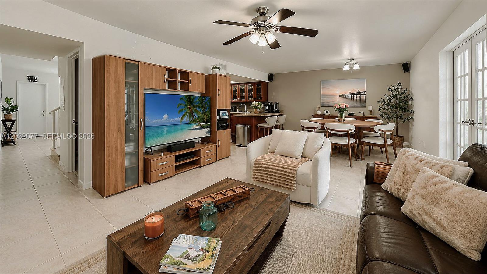 A living room and dining area feature tile floors, a wooden entertainment center, and furniture — 14 Matador Ln # 27, Davie FL 33324, DAVIE, FL