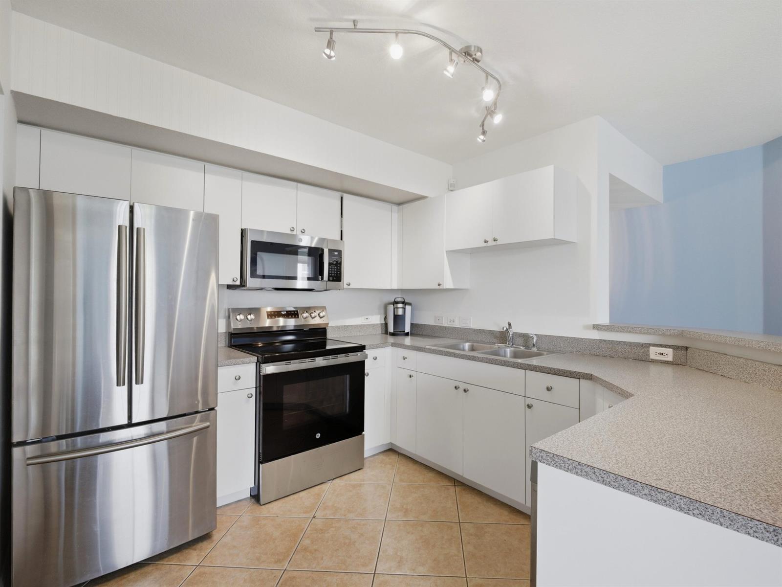 A kitchen with white cabinets, stainless steel appliances, and gray speckled countertops — 316 Villa Circle, Boynton Beach FL 33435, BOYNTON BEACH, FL