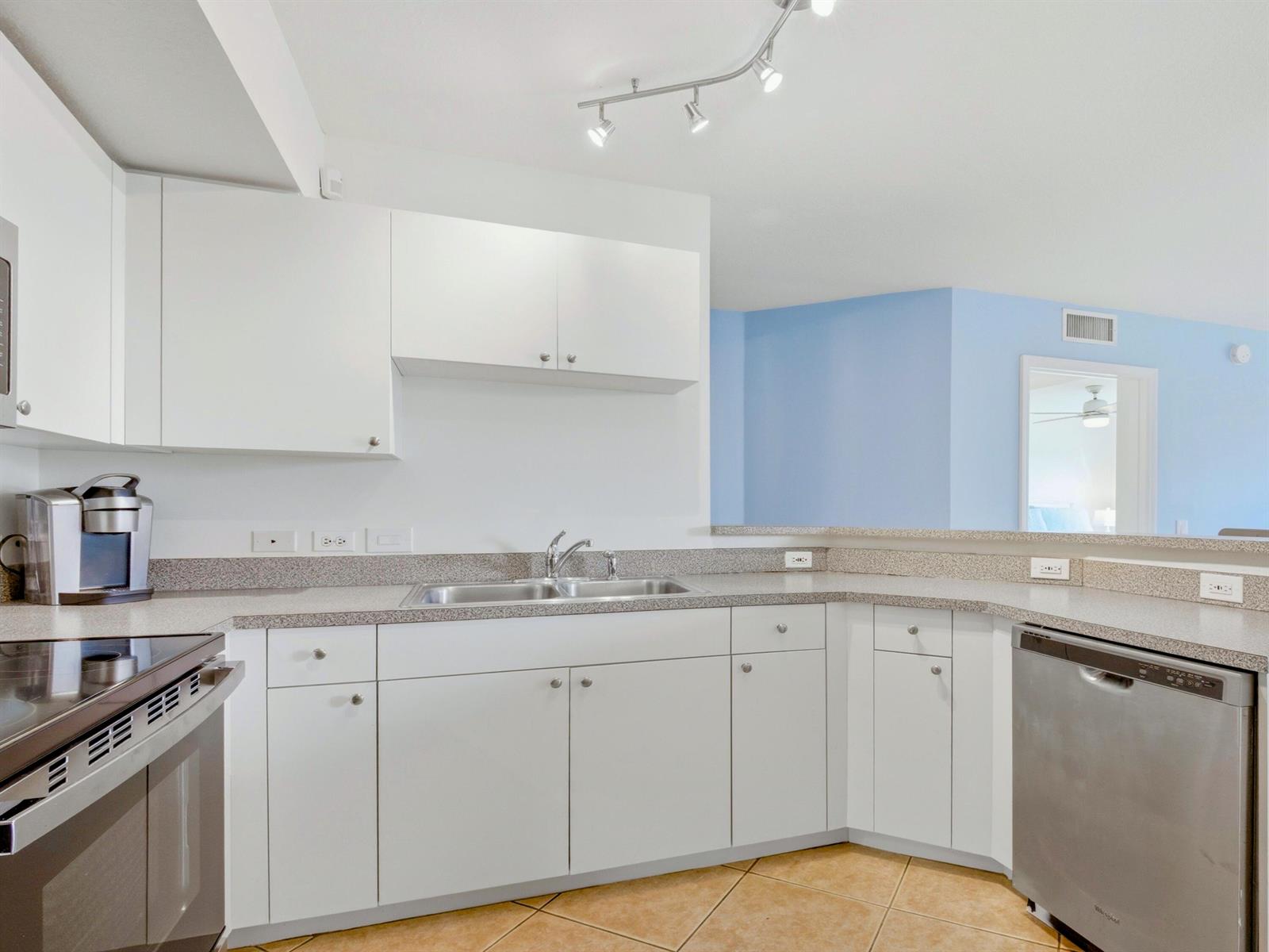 A kitchen with white cabinets, granite countertops, stainless steel appliances, and light blue walls — 316 Villa Circle, Boynton Beach FL 33435, BOYNTON BEACH, FL