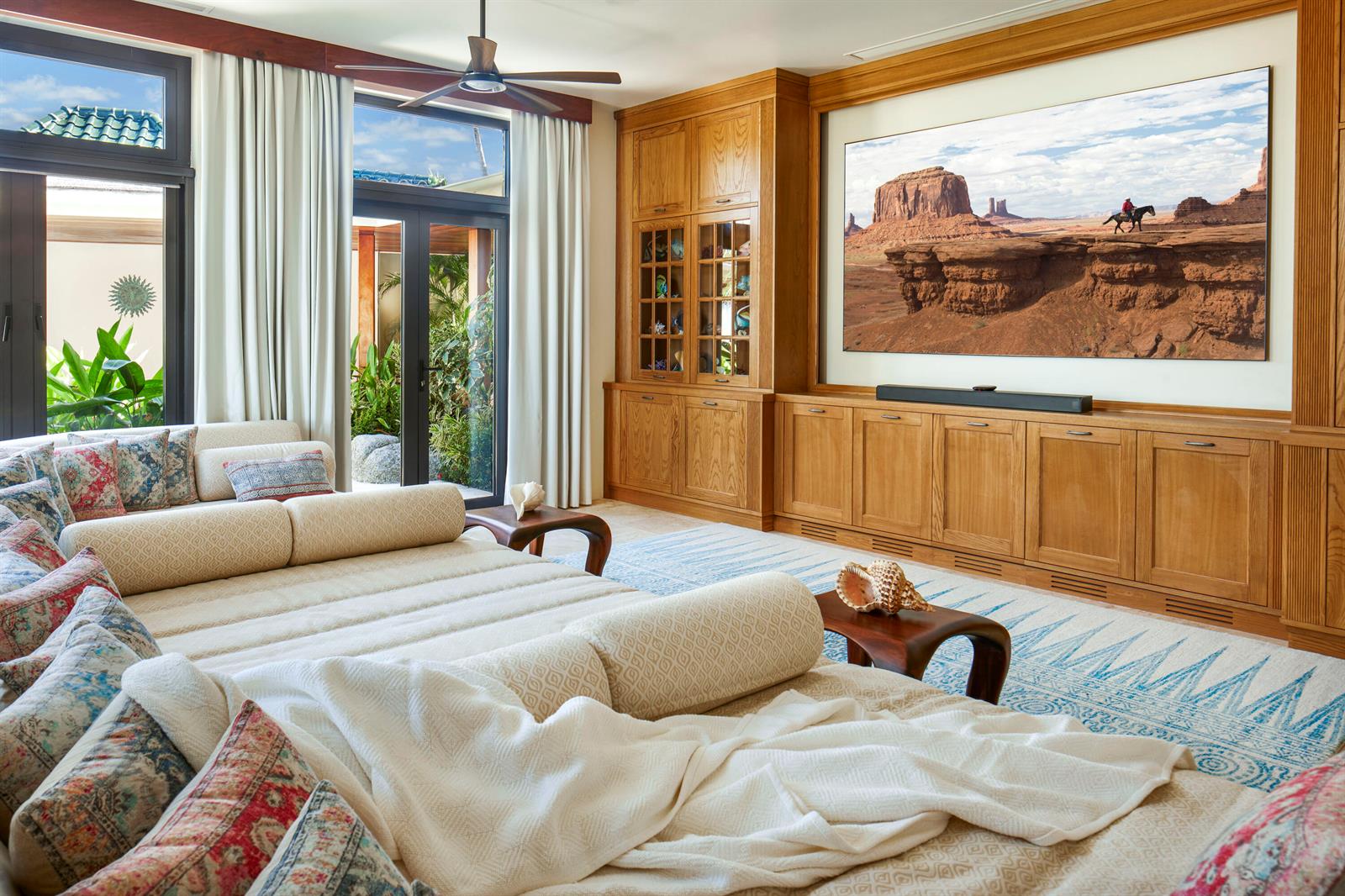 A living room features a large television, custom wood cabinetry, and a spacious sectional sofa — 0 Valley Trunk Est-Virgin Gorda, FL