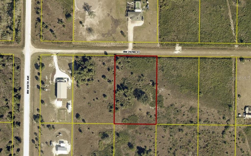 This aerial view shows a rectangular, undeveloped plot of land outlined in red — 20692 NW 282ND STREET, OKEECHOBEE, FL