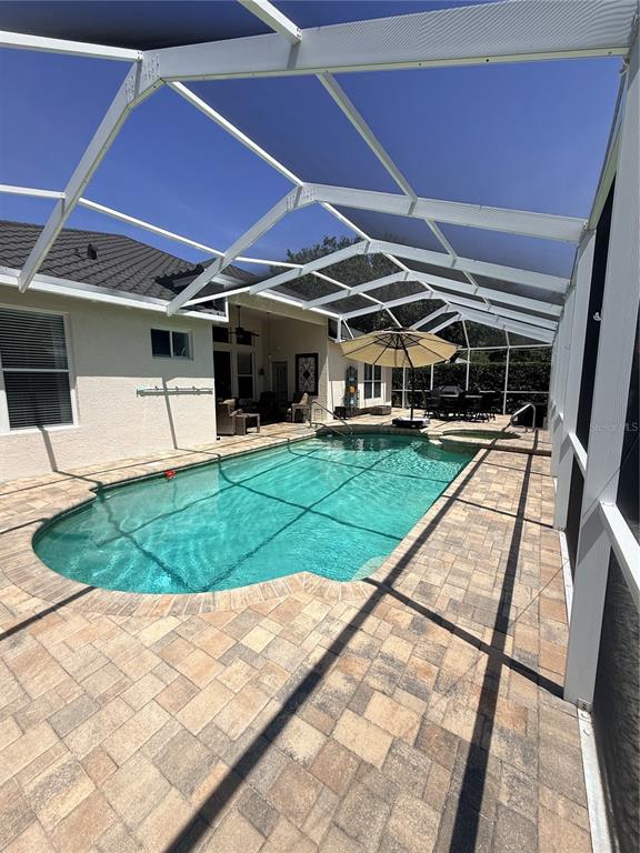 A living room features a large sofa, two armchairs, a fireplace, and high ceilings — 10236 ESTUARY DRIVE, TAMPA, FL