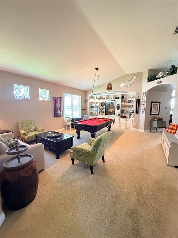 A kitchen with light wood cabinets, a central island, and an adjacent dining area — 10236 ESTUARY DRIVE, TAMPA, FL