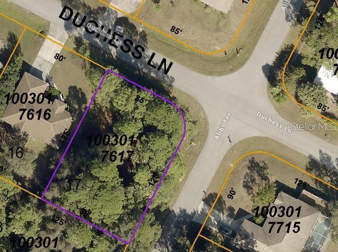 This is an aerial map showing a vacant lot outlined in purple at a street intersection — ALIBI TERRACE, NORTH PORT, FL