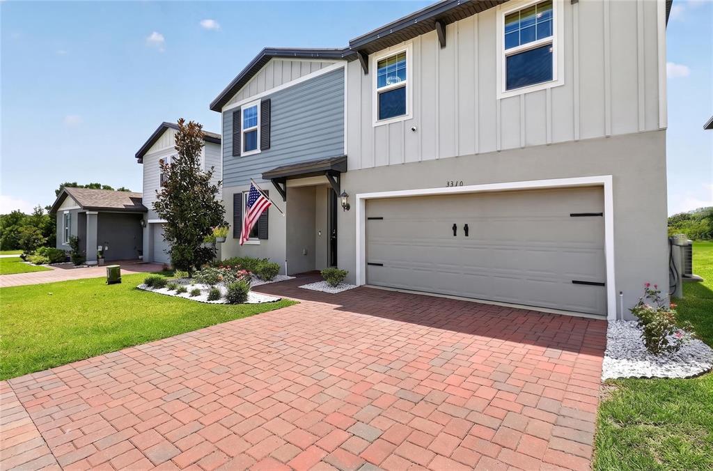A two-story house with a brick paver driveway and a two-car garage — 3310 WEITZEL DRIVE, HAINES CITY, FL