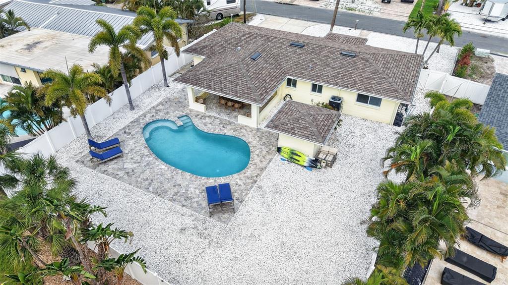 An aerial view shows a house with a pool, patio, and palm trees — 517 39TH AVENUE, ST PETE BEACH, FL