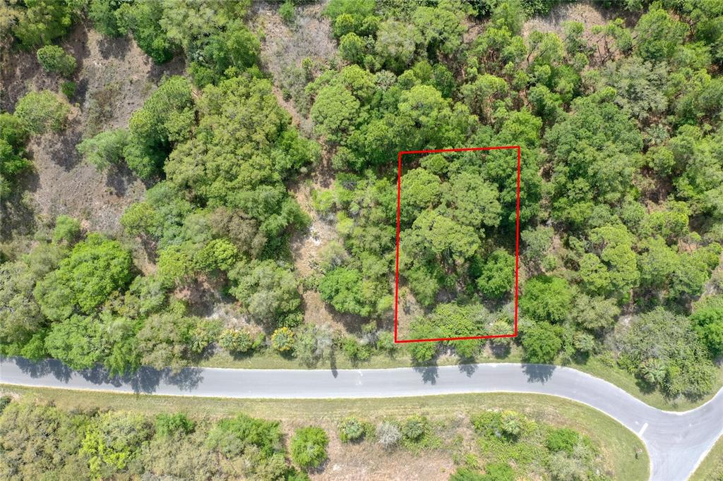 An aerial view shows a rectangular plot of land outlined in red near a road — 15047 DORN TERRACE, PORT CHARLOTTE, FL