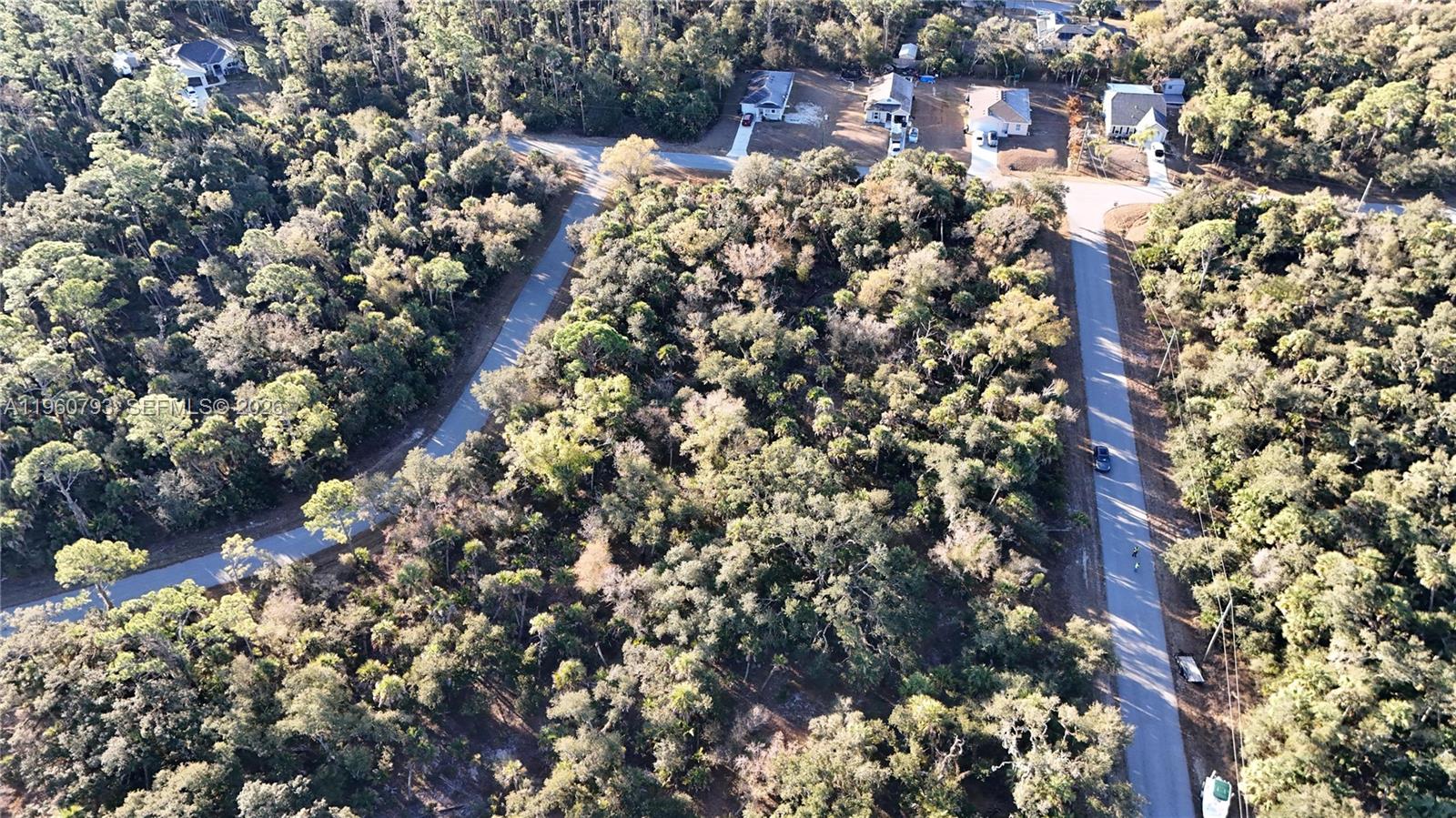 An aerial view shows a wooded residential lot situated between two paved roads — 0 BACKERT RD, North Port FL 34291, NORTH PORT, FL