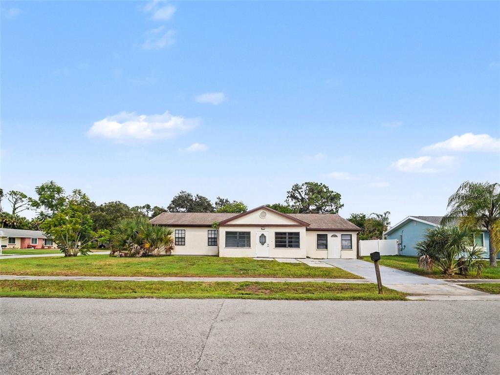 A single-story house with a light-colored exterior, a gabled roof, and a concrete driveway — 4060 AVANTI CIRCLE, NORTH PORT, FL