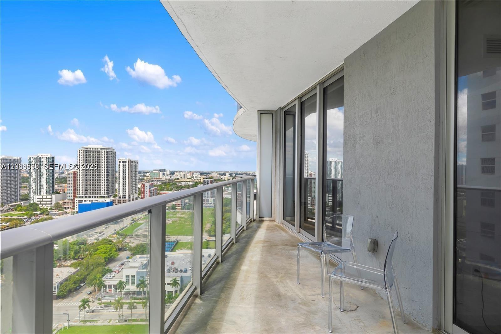 A modern kitchen features dark wood cabinetry, stainless steel appliances, and white countertops — 488 NE 18th St # 2802, Miami FL 33132, MIAMI, FL