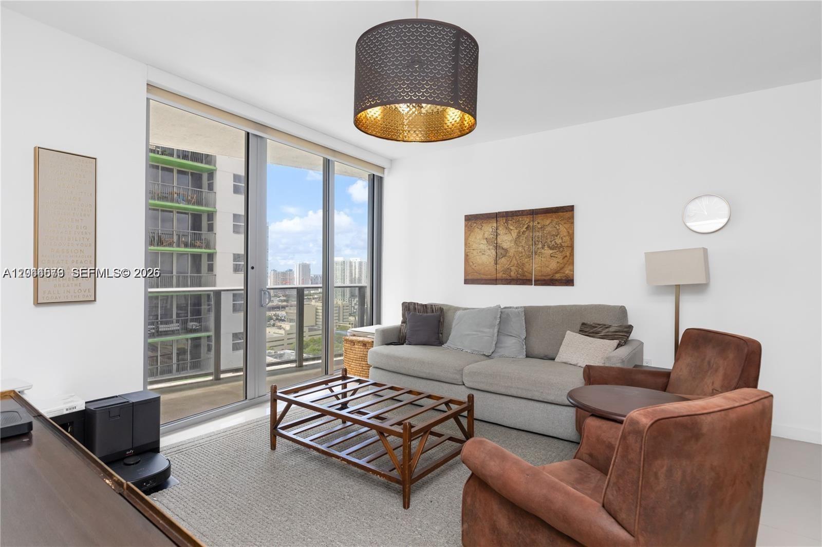 A modern kitchen features dark wood cabinets, stainless steel appliances, and light-colored tile flooring — 488 NE 18th St # 2802, Miami FL 33132, MIAMI, FL
