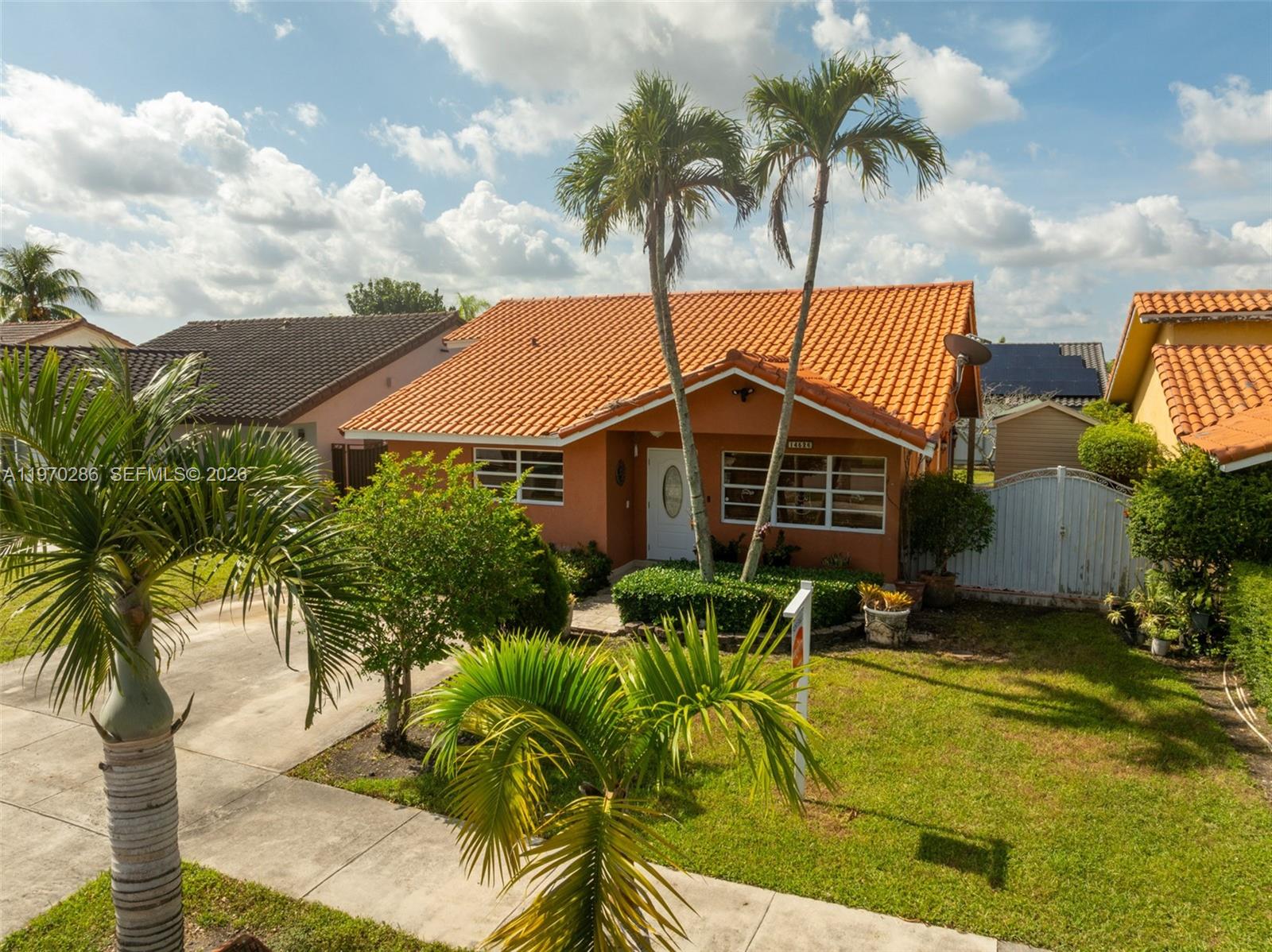 A single-story house with an orange tile roof and two palm trees in the front yard — 14526 SW 106th Ter, Miami FL 33186, MIAMI, FL