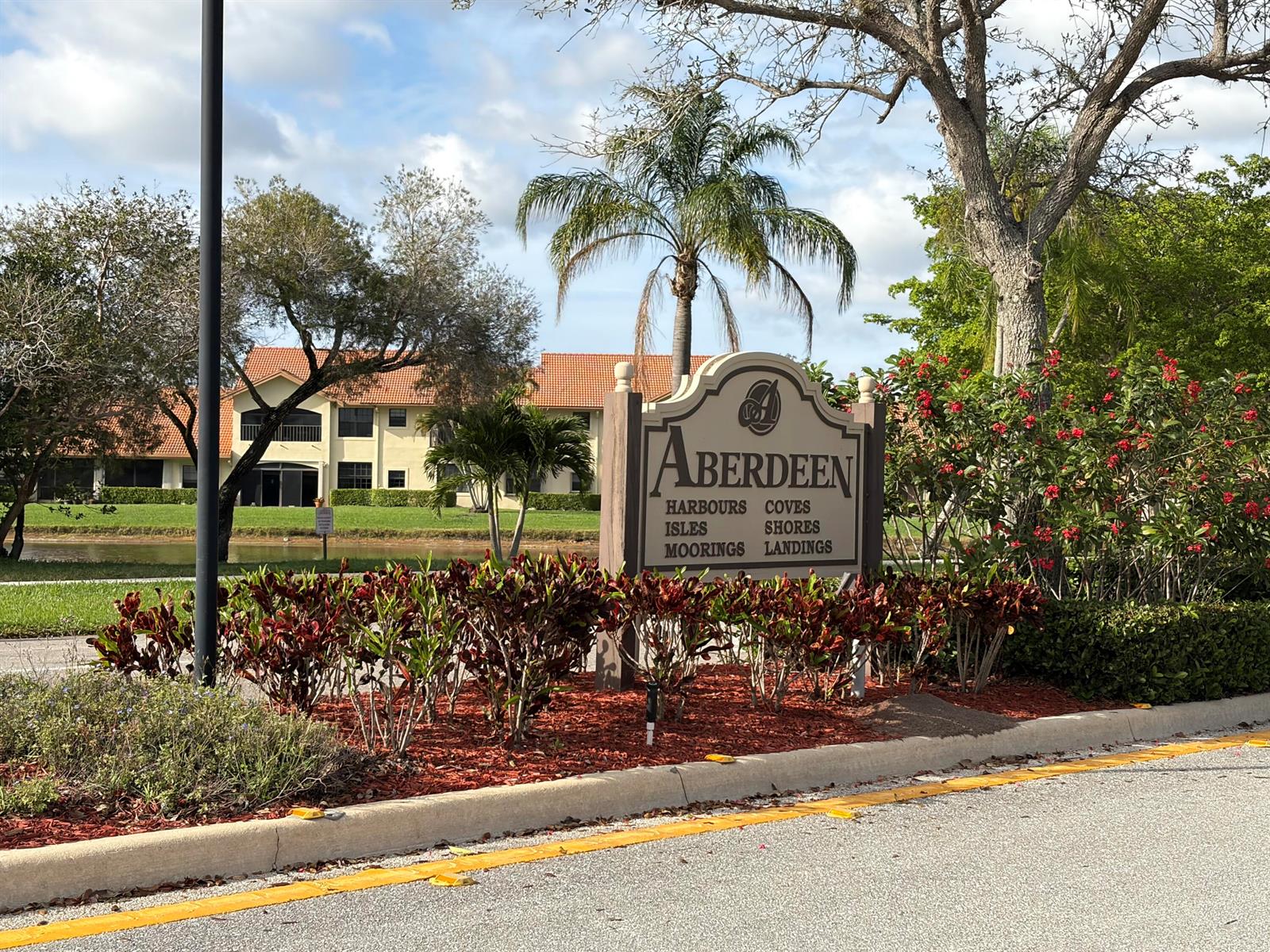 A sign for Aberdeen residential community stands in front of a pond and apartment buildings — 8232 Waterline Drive, Boynton Beach FL 33472, BOYNTON BEACH, FL