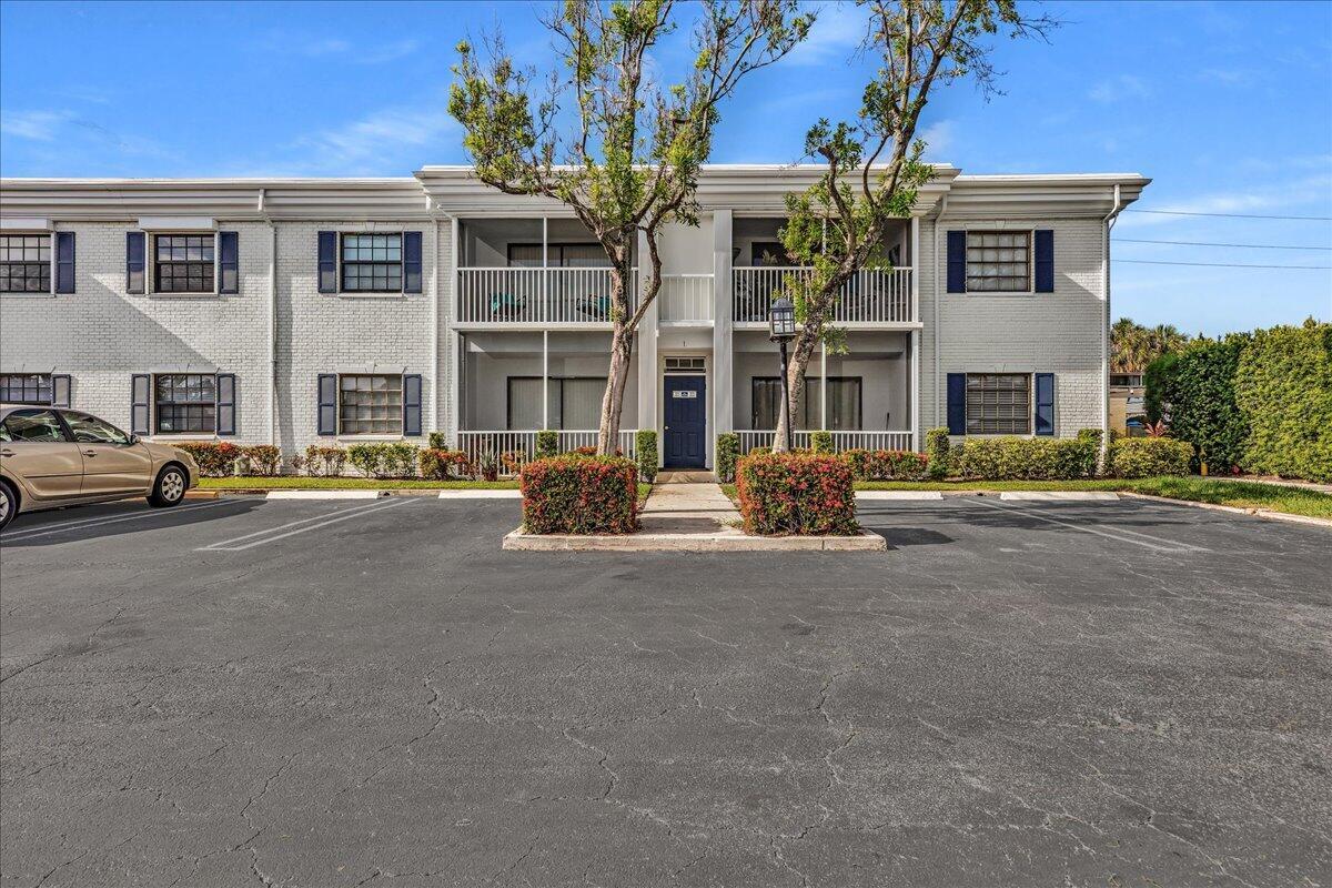 A two-story apartment building with a white brick facade and a parking lot in front — 180 Cypress Club Drive # 816, Pompano Beach FL 33060, POMPANO BEACH, FL
