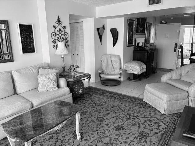 A living room features a sofa, patterned area rug, marble coffee table, and accent chairs — 101 Briny Avenue # 707, Pompano Beach FL 33062, POMPANO BEACH, FL