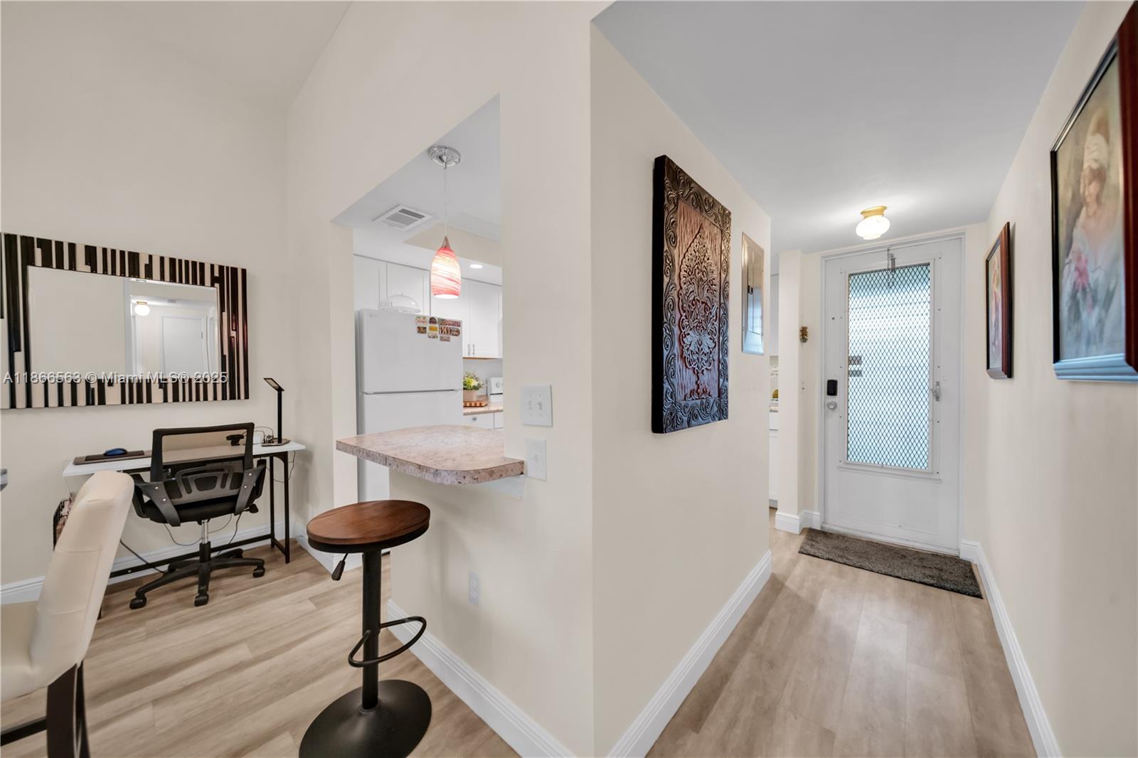 A view of an entryway leading to a kitchen with a breakfast bar and desk — 4613 SE 5th ave # 210, Cape Coral FL 33904, CAPE CORAL, FL