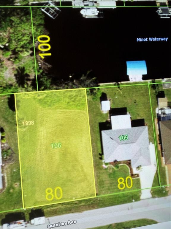 This aerial map shows a vacant residential lot next to a house on a waterway — 12350 QUINLAN AVENUE, PORT CHARLOTTE, FL