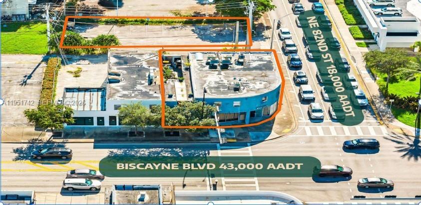 This aerial view shows a commercial building with a parking lot on a corner lot — 8201 Biscayne Blvd, Miami FL 33138, MIAMI, FL
