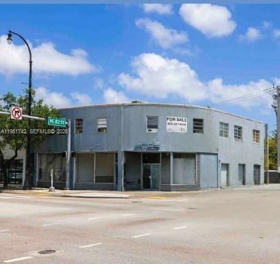 A two-story commercial building with a curved corner sits at a street intersection — 8201 Biscayne Blvd, Miami FL 33138, MIAMI, FL