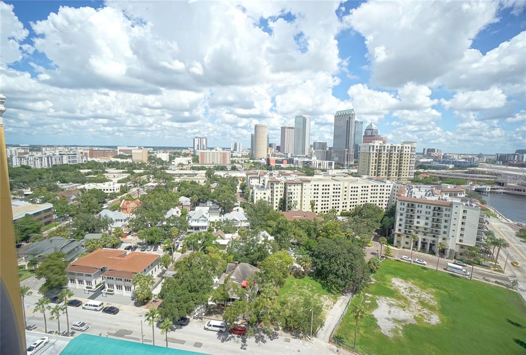 An elevated view of a city skyline with buildings, trees, and a large grassy lot — 345 BAYSHORE BOULEVARD UNIT 1810, TAMPA, FL