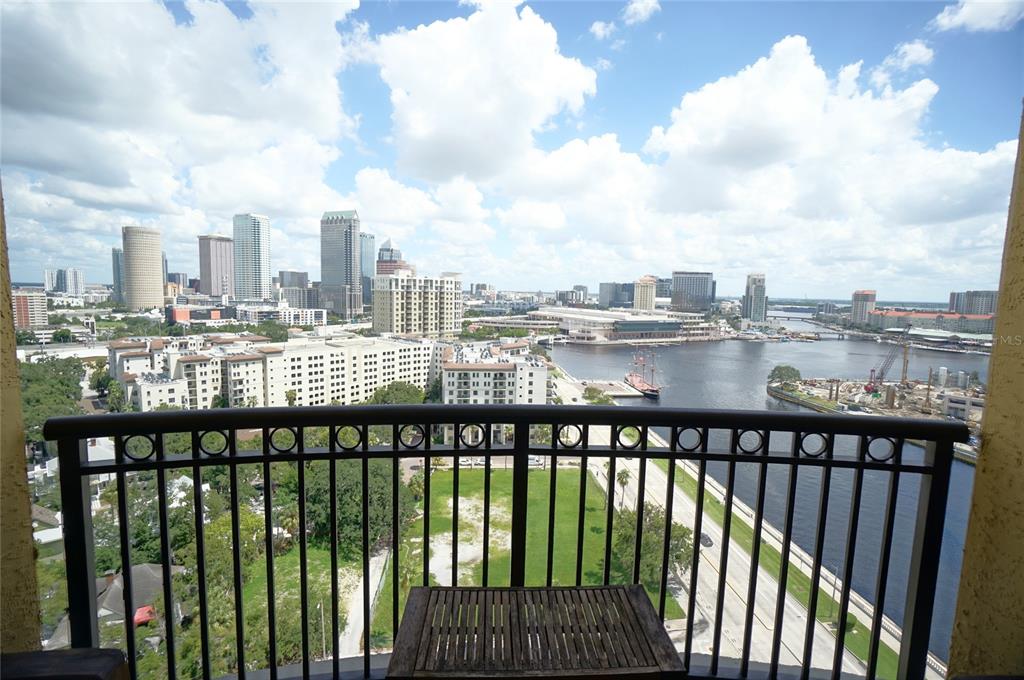 A balcony overlooks a city skyline, a river, and a construction site — 345 BAYSHORE BOULEVARD UNIT 1810, TAMPA, FL