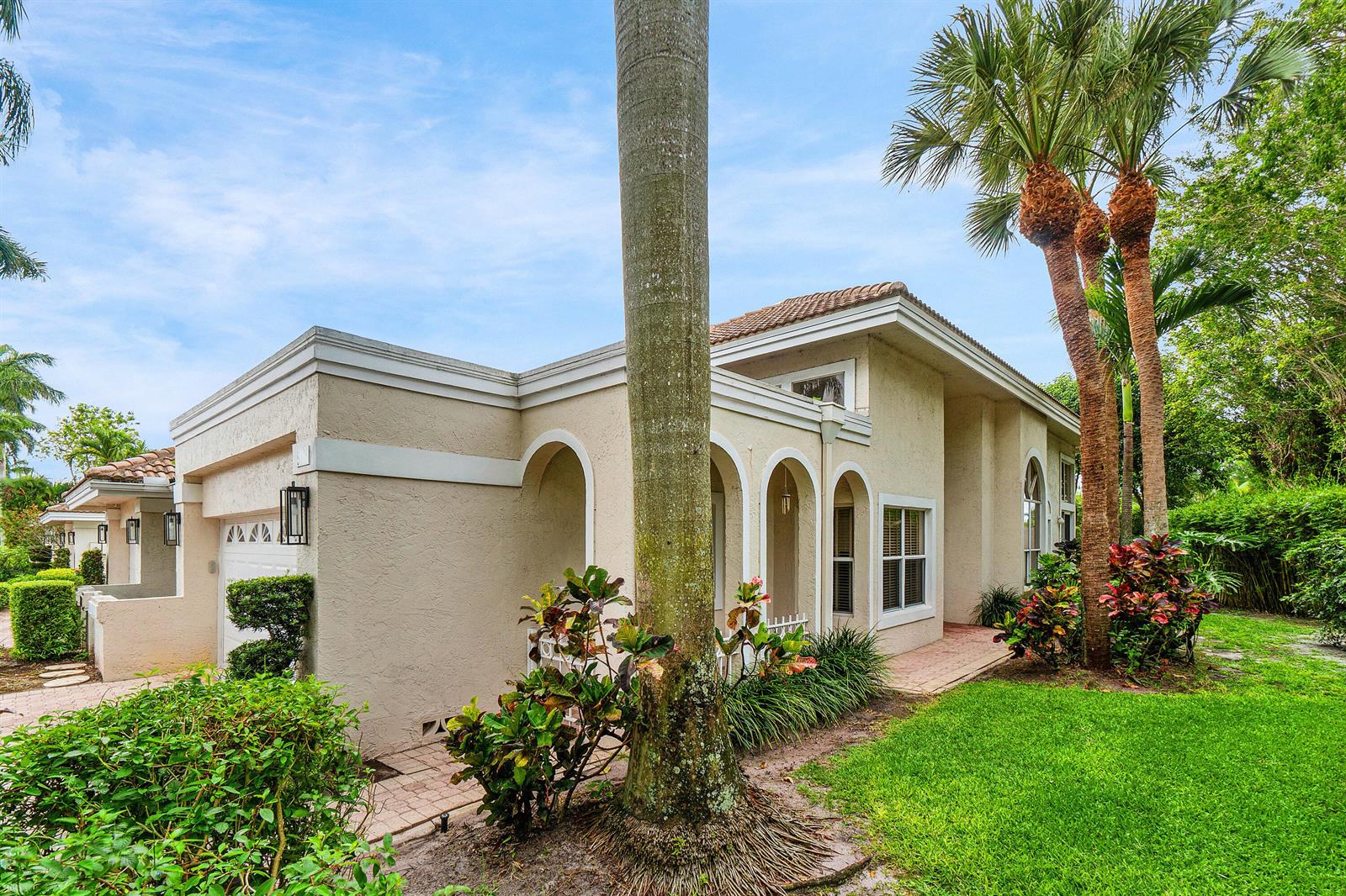 A beige stucco house with arched entryways, a palm tree, and a manicured lawn — 5106 Windsor Parke Drive, Boca Raton FL 33496, BOCA RATON, FL