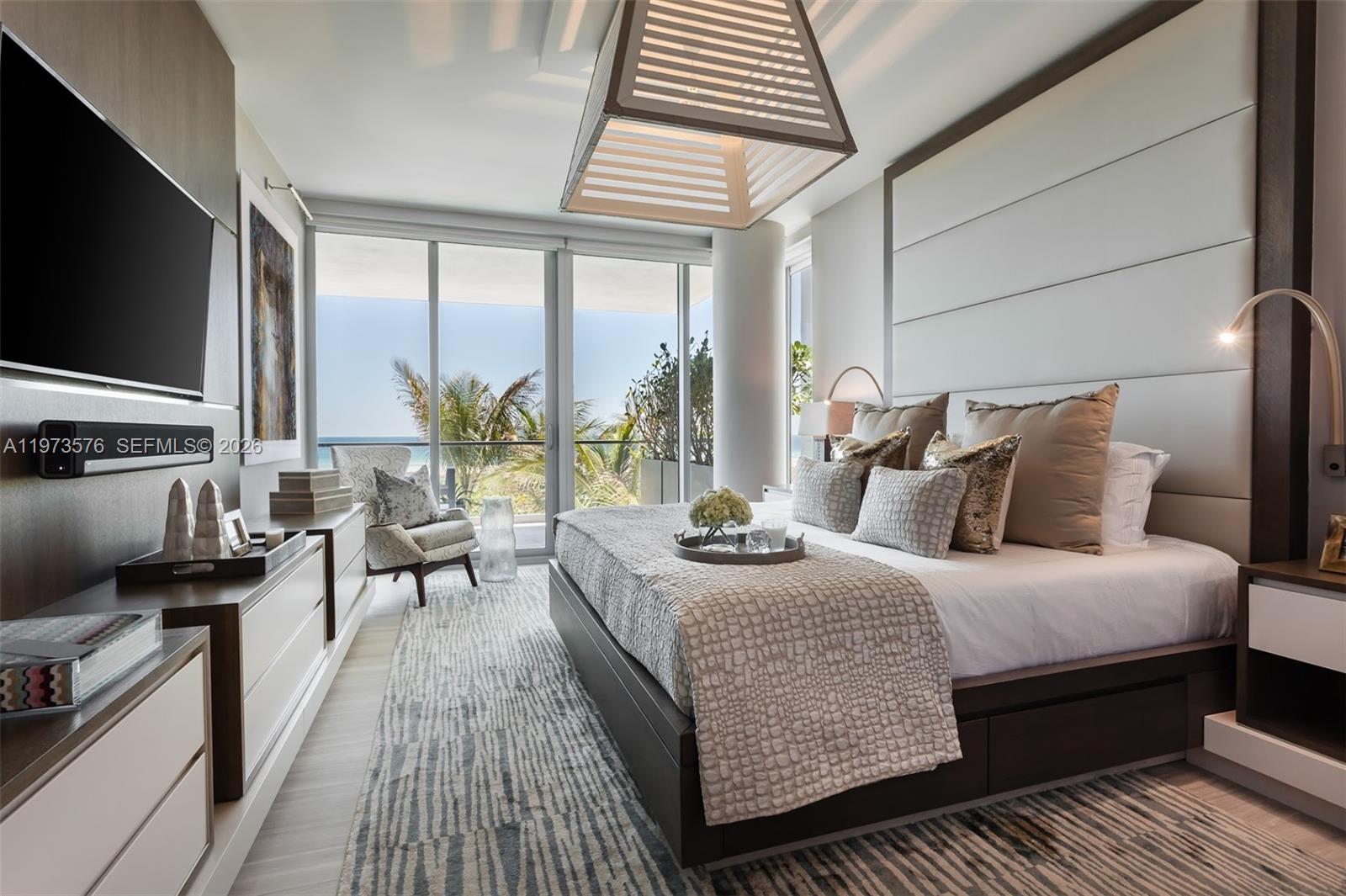 A modern bedroom features a king bed, a large window with ocean views, and contemporary decor — 321 Ocean Dr # 200, Miami Beach FL 33139, MIAMI BEACH, FL