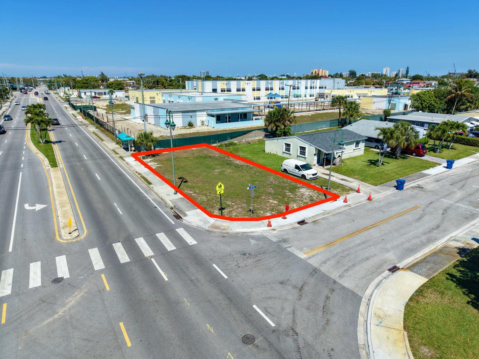 An aerial view shows a vacant corner lot outlined in red next to a house — 0 Australian Avenue, Riviera Beach FL 33404, RIVIERA BEACH, FL