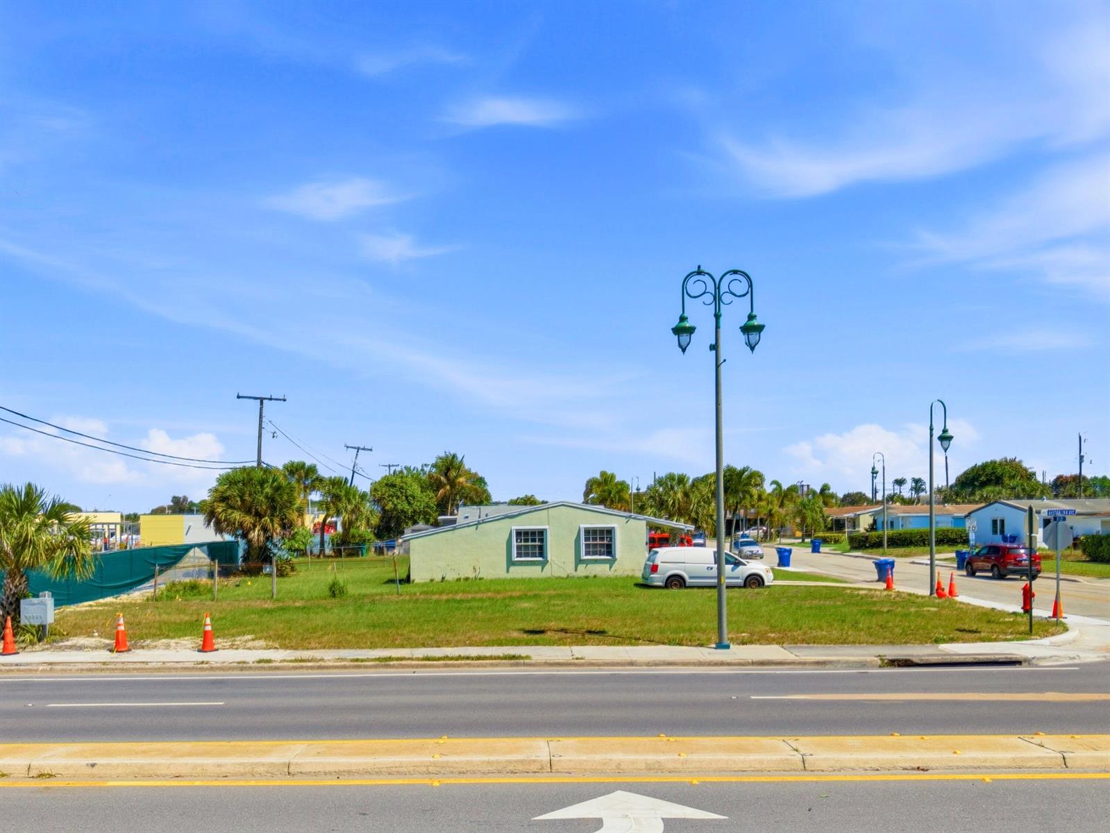 A single-story light green house sits on a grassy lot near a street — 0 Australian Avenue, Riviera Beach FL 33404, RIVIERA BEACH, FL