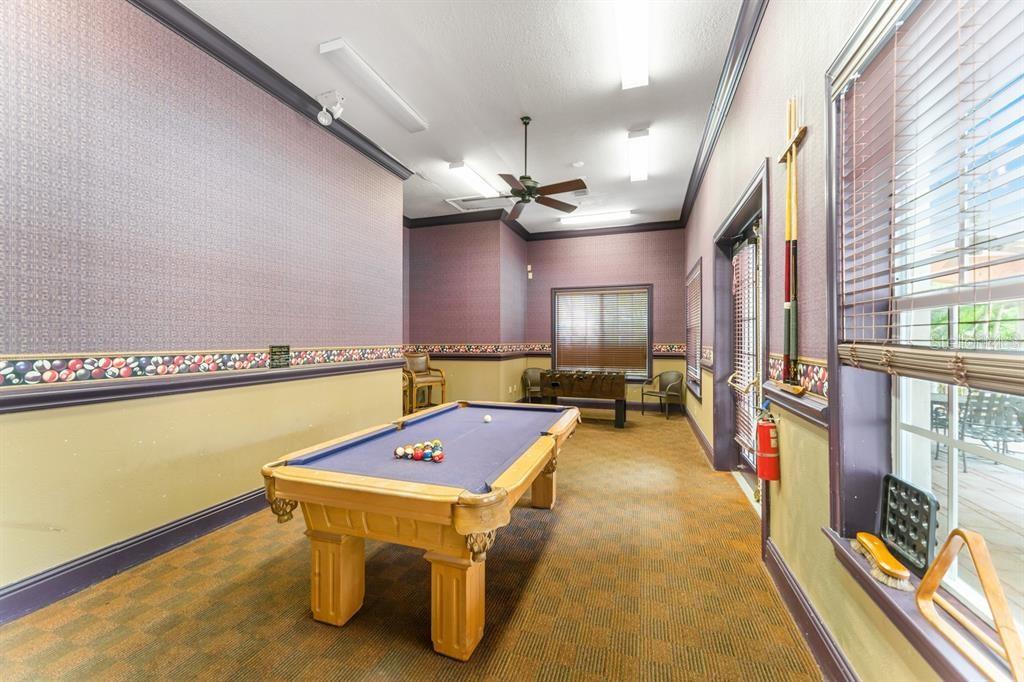 A game room features a pool table, foosball table, patterned carpet, and purple wallpaper — 4126 CENTRAL SARASOTA PARKWAY UNIT 2012, SARASOTA, FL
