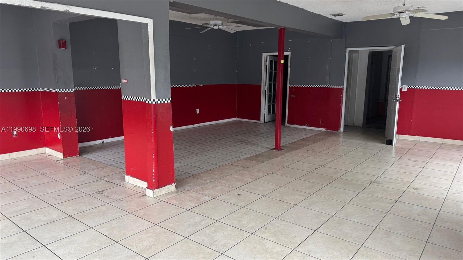 An interior commercial space features tiled floors, gray and red walls, and a support column — 210 SW 22nd Ave, Miami FL 33135, MIAMI, FL