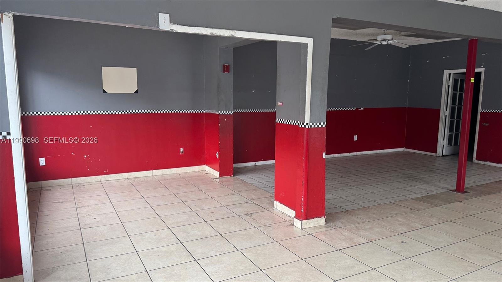 An empty commercial space features gray and red walls with a black-and-white checkered border — 210 SW 22nd Ave, Miami FL 33135, MIAMI, FL
