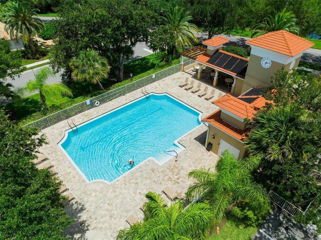 An aerial view of a rectangular swimming pool with a covered patio and clock tower — 1036 OAK MEADOW LANE, OSPREY, FL