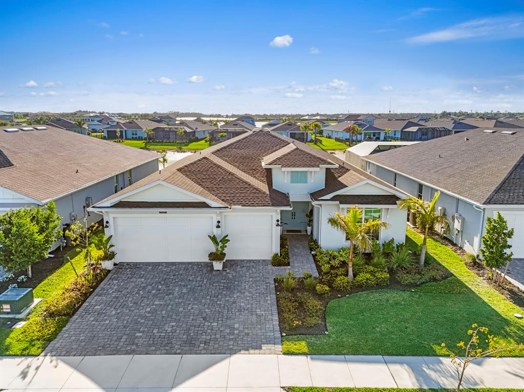 An aerial view of a single-story suburban house with a paved driveway and landscaped yard — 16261 PRESERVATION BOULEVARD, PUNTA GORDA, FL