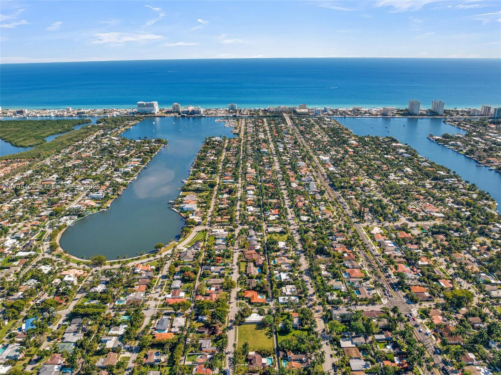 An aerial view shows a residential neighborhood situated between two bodies of water near the ocean — 1312 Polk St, Hollywood FL 33019, HOLLYWOOD, FL